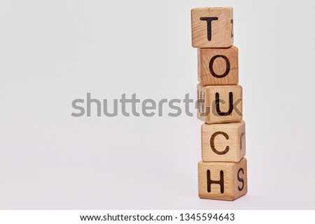 wooden cubes on a white background and the word laid down  touch