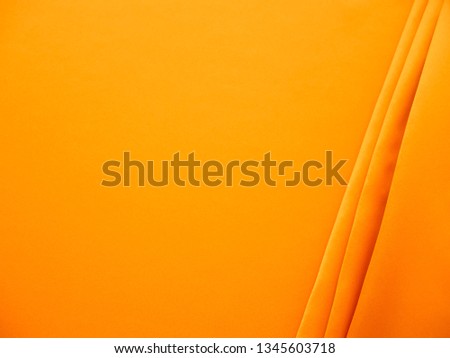 Beautiful smooth elegant wavy yellow satin silk luxury cloth fabric texture, abstract background design. Wallpaper, banner or card with copy space.
