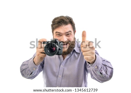 portrait of smiling big handsome bearded photographer taking photo with professional DSLR camera, isolated on white background