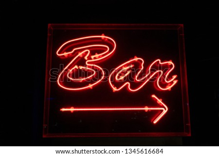 Red light sign showing the direction to the bar on board a cruise ship