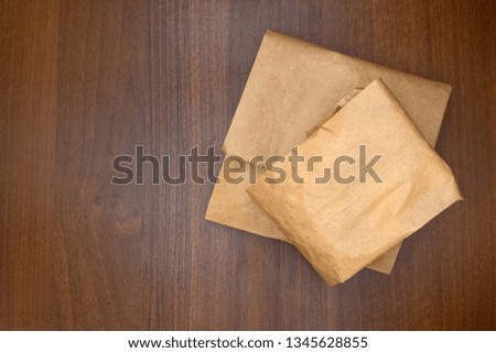 Paper packaging bags of food are on the table. Walnut background. The concept of using environmentally friendly packaging. The texture is wooden. Copy space.