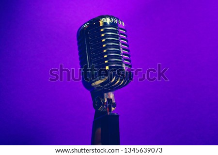Retro dynamic microphone, on a purple vibrant background. Artistic style music concept