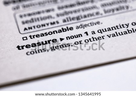 Blurred close up to the partial dictionary definition of Treasure