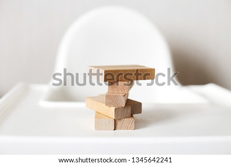 wooden pyramid on the highchair.  stick game.