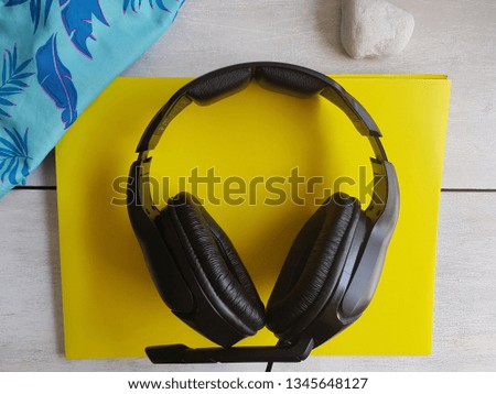 Headphones on yellow background, holidays concept