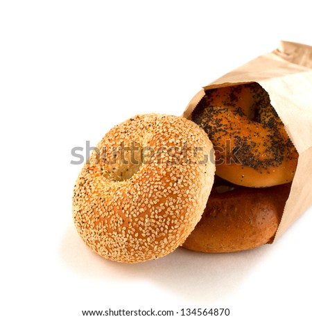 Assorted bagels in brown paper bag