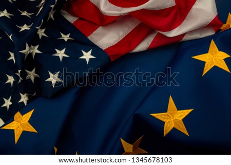 TTIP, USA and EU cooperation and Transatlantic Trade and Investment Partnership concept theme with the flags of the United states of America and the European Union Royalty-Free Stock Photo #1345678103
