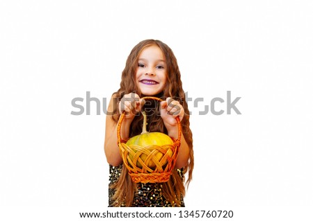 Little girl with long hair in witch clothes, holding a pumpkin, emotional portrait on a white background