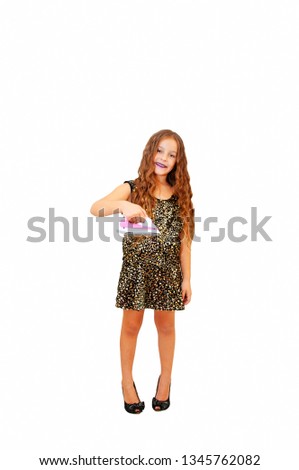 Glamor little girl with long hair in a smart dress on high-heeled shoes, with an iron, posing emotionally, isolated on a white background