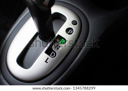 Put a gear stick into R position, (Reverse) Symbol in auto transmission car. Royalty-Free Stock Photo #1345788299
