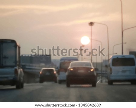 Blurry and soft focus at many car on the main road. Copy space and Sunset Background. Driver perspective. Concept Holiday travel, Go back home , Missing home, Safety and dangerous on street.