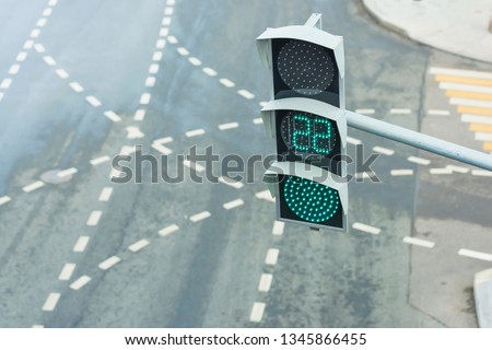 Green traffic light. Modern traffic lights with a timer. Road traffic in the big city. Road markings at a regulated intersection. Pedestrian crossing in the metropolis