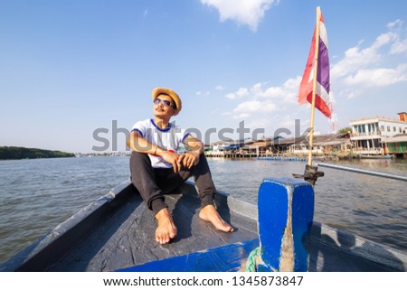 A man relaxing happily on the vacation sailboat yacht having a rest on summer boat and blue sky background.