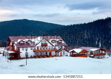 Ski resort, in the style of an Alpine village, cozy cottages for recreation in the winter