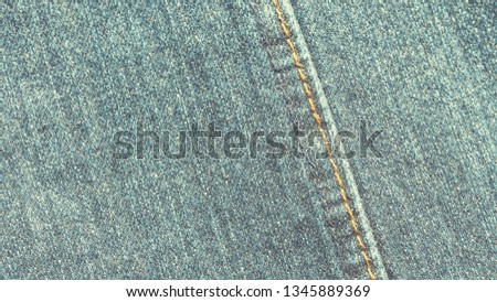 Retro style detail of denim blue jeans fabric texture pattern design, vintage color tone process for background