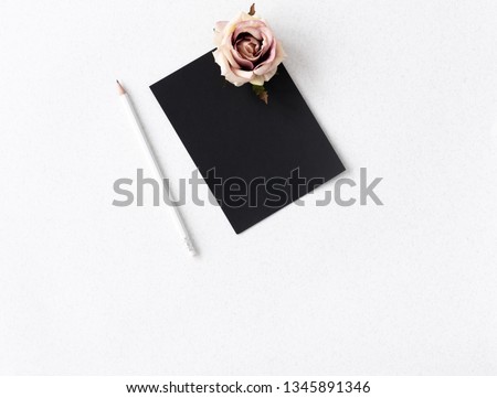 space black board with rose flower and white pencil