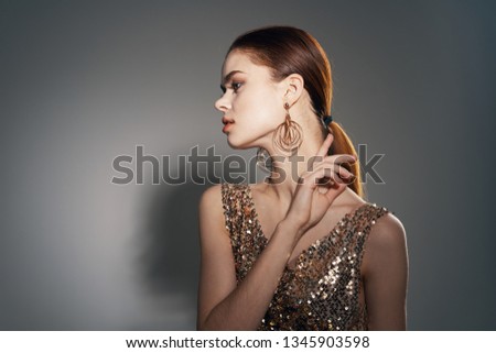 beautiful woman with red hair and dress with sequins                       