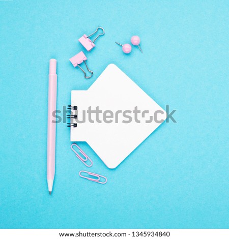 Notebook, pen, paper clips on pastel paper background. Top view. Place for text. Horizontal