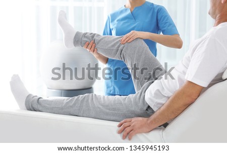 Doctor working with patient in hospital, closeup. Rehabilitation physiotherapy Royalty-Free Stock Photo #1345945193