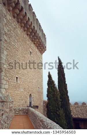 Blue sky and pretty view. Castle on the hills in Spain. Parador de Alarcón, Cuenca. Júcar River. Wall and trees.