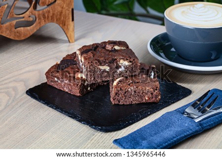 Close up view on stack of homemade brownies with coffee. Useful picture for recipe or menu. Copy space for design. Fresh bakery and dessert.