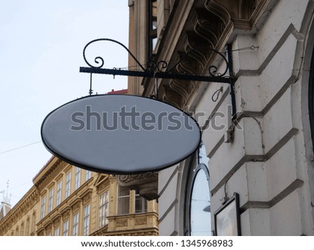 Signboard template of an elegant store on the streets against the background of the wall. Antique building architecture in Europe. Sing board mockup for store with copy space
