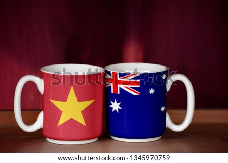 Australia and Vietnam flag on two cups with blurry background