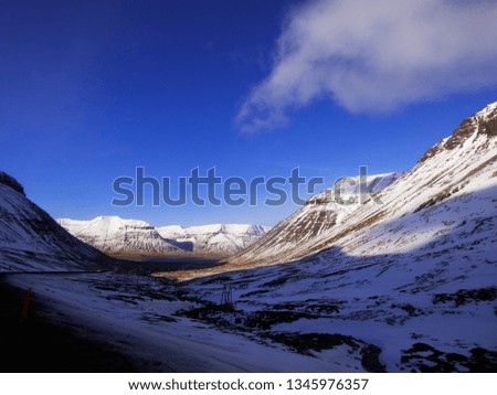 Nice calming valley lanscape with mountain tops peaks in the background nice snowy place