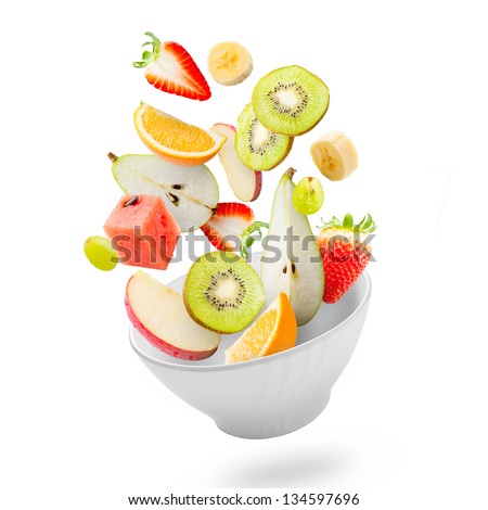 Assorted fresh fruits flying in a bowl/ Light salad with flying fresh fruits Royalty-Free Stock Photo #134597696