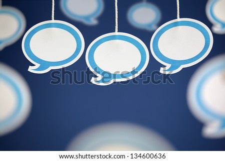 Blank white speech bubbles hanging from string