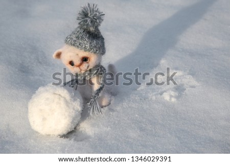 winter holidays concept, little kitten sculpts a snow globe