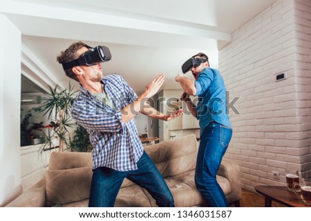 Happy friends playing video games with virtual reality glasses - Young people having fun with new technology console online