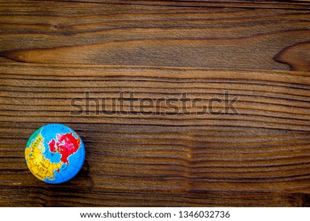 SOS Save the planet concept with the earth on dark wooden background flat lay moke-up