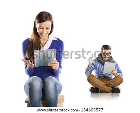 Beautiful young woman and man with tablet in studio