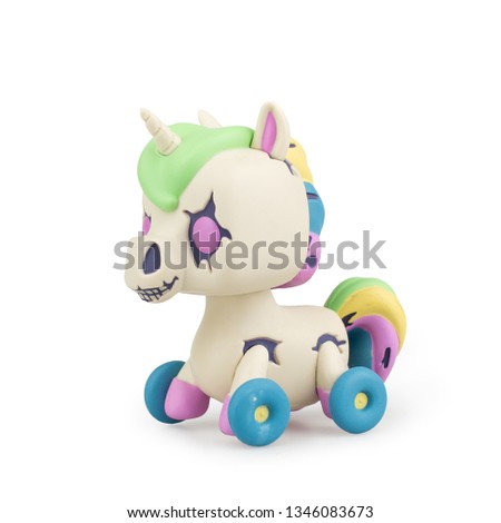 Baby toy unicorn on wheels on white background