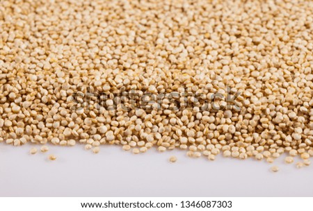 Natural background of quinoa seeds on white surface. Organic food for healthy eating