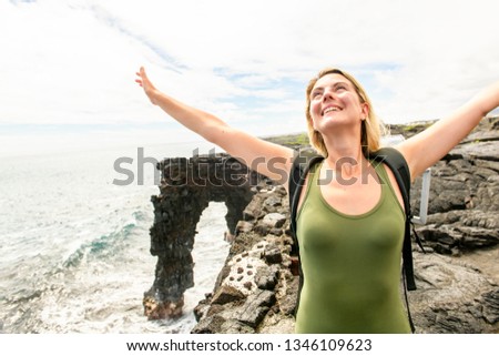 A woman at the Holei Sea Arch, Hawaii Volcanoes National Park