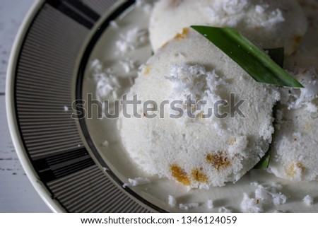 "Putu Piring" is traditional Malaysia dessert made from coconut, rice flour and palm sugar, steamed cook. Selective focus.