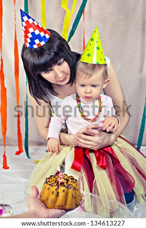Portrait of mother with baby celebrating first birthday
