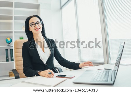 The businesswoman working with a laptop at the desk
