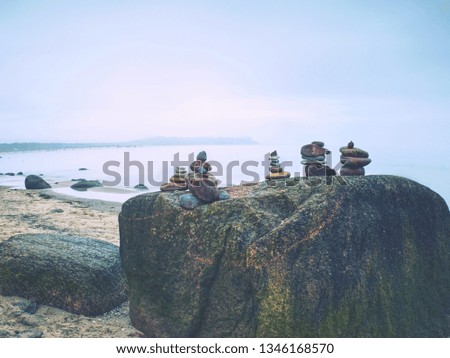 Detailed pile of stacked stones on the beach. Huge amount of zen stones pyramids in the beach