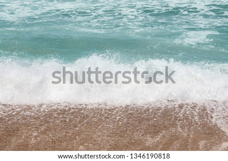 Waves breaking on the beach sand