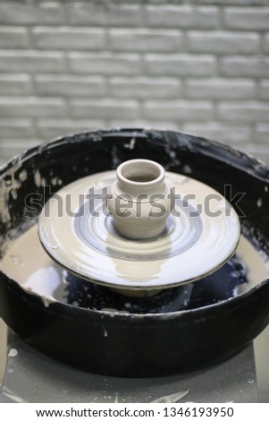 Clay vessel on the Potter's wheel in the pottery.