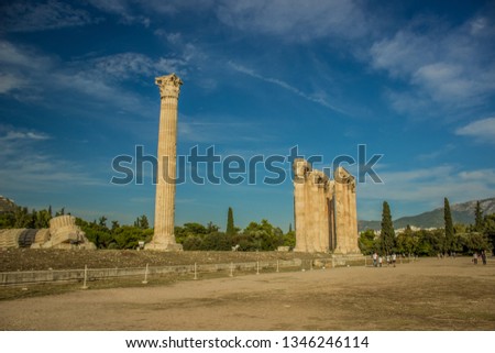 tourism and sightseeing concept of destroyed marble pillars building of ruined temple from ancient Greece times in park outdoor natural environment 