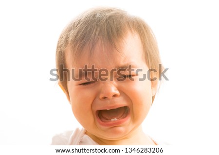 Close up of a 1 year old baby girl crying