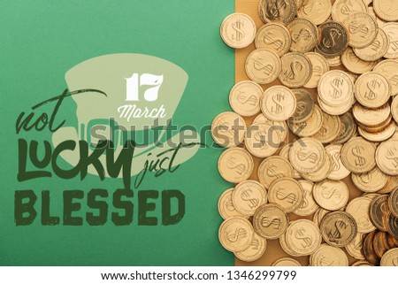 top view of golden coins near not lucky just blessed lettering on green background