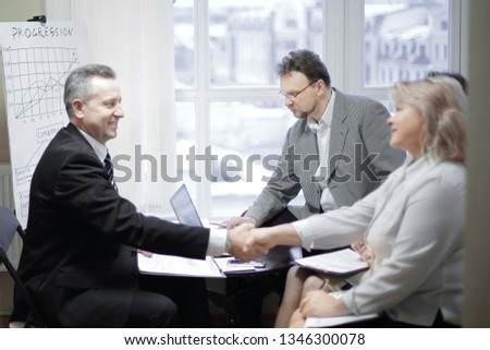 handshake of a businessman and business woman at a meeting