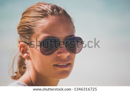 Portrait of aYoung surfer girl on a Hawaiian beach in Oahu