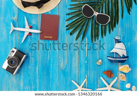 Travel Plan. Traveler planning trips summer vacations on the beach with Traveler's accessories, retro camera, sunblock, sunglass in summertime.  Top view and copy space for banner.  Holiday Summer.