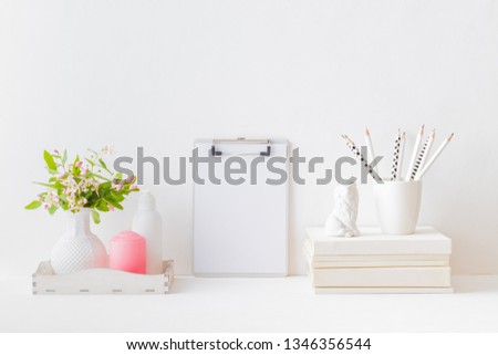 Home interior with decor elements. Mockup clipboard, branches with green leaves in a vase, interior decoration
